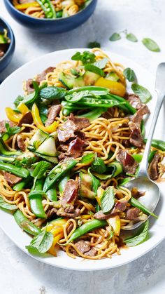 a white plate topped with noodles and veggies