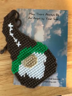 a crocheted bookmark with a football hat on it