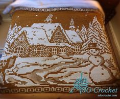 a close up of a pillow with a house on it