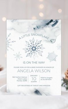 the snowflake is on the way baby shower in blue and white marbled paper