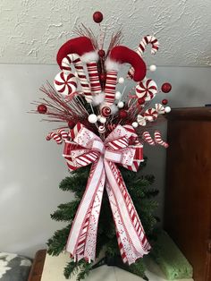 a decorated christmas tree with candy canes and candies on it's top