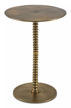 an antique brass pedestal table with spiral design on the base and round metal plate at the top