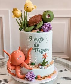 there is a cake decorated with sea animals on the top and bottom, along with other decorations