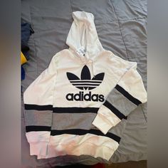 This Is An Adidas Original Hoodie From About Four Years Ago. It Went Into My Storage Unit And Never Came Out Until Now. It In Perfect Condition No Stains Never Been Worn With Tag On. This Is One Of The Harder Pieces For Me To Part With. I Love It So Much But If I Get What I’m Asking For I’m Willing To Part With It I’m Asking 90 But Will Take Reasonable Offers As They No Longer Make This Style. Please Feel Free To Reach Out If You Have Any Questions. White Urban Hoodie With Logo Print, Casual Adidas Logo Fleece Hoodie, Cotton Hoodie With Three Stripes And Crew Neck, White Long Sleeve Hoodie For Sports Season, Casual Adidas Logo Hoodie For Sports Season, Casual Adidas Hoodie For Sports Season, Casual Hoodie With Three Stripes For Sports Season, Casual Fleece Hoodie With Three Stripes, White Sporty Sweatshirt With Ribbed Cuffs