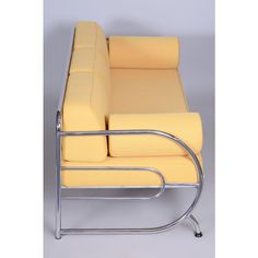 a yellow chair sitting on top of a metal frame