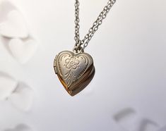 "A tiny silver heart locket hangs from a silver chain. Please select a length from the drop-down box. The necklaces's length in the last picture is 17 and 19 inches. The locket measures 1/2\" x 1/2\". *We do not personalize nor insert pictures. The locket and chain are rhodium plated over brass, so it's recommended removing before showering, swimming, etc. to keep jewelry looking like new." Locket Tattoos, Silver Heart Locket, Minimalist Necklace Gold, Silver Locket Necklace, Puffy Heart Charms, Silver Locket, Heart Locket Necklace, Locket Charms, Silver Heart Necklace