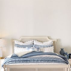 a bed with blue and white comforters in a bedroom