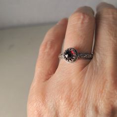 This handmade red garnet and sterling silver ring is influenced by Medieval metalwork. The 6mm (1/4 inch) genuine red garnet is a rose cut cabochon, faceted on the top and flat on the bottom. I have set it in fancy sterling silver gallery wire, like a crown. It sits on a ring shank that is a 3mm band of sterling silver in a stylized diamond and flower pattern. I give the ring an oxidized patina to enhance the detail. This ring is made to order Please allow 5 working days to make the ring ~before Anniversary Sterling Silver Ruby Ring With Rose Cut Diamonds, Silver Sterling Ruby Ring With Rose Cut Diamonds, Silver Ruby Ring With Rose Cut Diamonds For Promise, Silver Ruby Promise Ring With Rose Cut Diamonds, Victorian Silver Ring With Garnet, Victorian Garnet Silver Ring, Silver Garnet Rings With Bezel Setting, Victorian Style Garnet Silver Ring, Silver Birthstone Ring With Rose Cut Diamonds For Gift