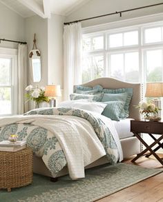 a bedroom with white and yellow bedding