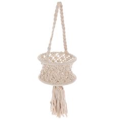 a macrame bag with tassels hanging from the front, on a white background