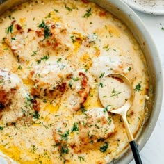 a pan filled with cheese and meat covered in gravy on top of a table