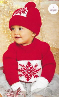 a baby wearing a red sweater and hat