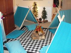 a room with blue chairs and black and white checkered table cloth on the floor