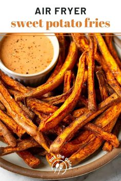 air fryer sweet potato fries on a plate with dipping sauce in the middle and text overlay