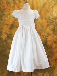 First Communion Dress Cotton Blend with Smocked Waist from Catholic Faith Store (7, White) White Cotton Dress With Pleated Bodice, Fitted Smock Wedding Dress, Fitted Wedding Dress With Smocked Cuffs, Short Sleeve Dress With Smocked Bodice For Wedding, Short Sleeve Wedding Dress With Smocked Bodice, Wedding Dress With Smocked Bodice And Short Sleeves, Elegant Smock Wedding Dress, Cotton Smocked Ruched Fitted Dress, Elegant Fitted Baptism Dress With Smocked Bodice