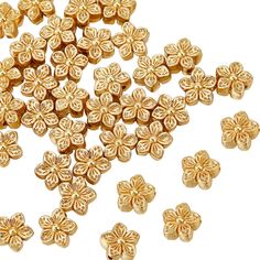 gold plated flower beads on white background