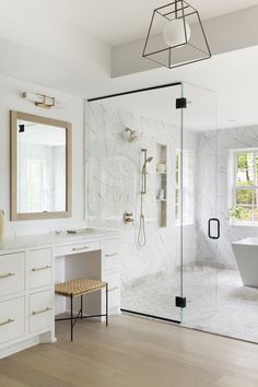 a bathroom with a tub, sink and mirror in the middle of it's walls