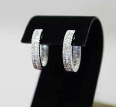 Diamond set hoop earrings in 18ct white gold A row of baguette cut diamond is set in between the rows of round cut diamond, inside and out  Hinged click closure for security Total baguette cut diamond 0.66ct Total round cut diamond 0.83ct Total Diamond Weight: 1.49cts Luxury Gia Certified Baguette Cut Earrings, Silver Emerald-cut Baguette Diamond Earrings, Silver Emerald Cut Diamond Earrings With Baguettes, Classic Silver Baguette-cut Hoop Earrings, Classic Silver Baguette Cut Hoop Earrings, Baguette Diamond Hoop Earrings For Anniversary, Round Hoop Earrings With Baguette Diamonds For Anniversary, Formal Hoop Jewelry With Baguette Diamonds, Formal Hoop Earrings With Baguette Diamonds