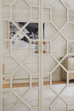 an ornate mirrored closet door in a bedroom