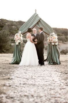 a man and woman standing under a tent