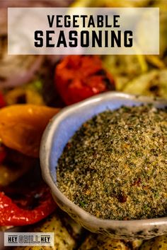 a close up of a bowl of seasoning next to some vegetables and peppers with the words vegetable seasoning on it