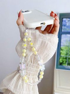 a woman is holding up her phone case