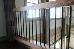 a wooden and metal railing in front of a window