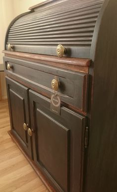 an old fashioned wooden dresser with brass knobs and handles on it's doors