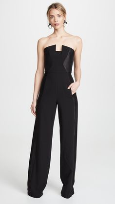 Fabric: Mid-weight, stretch suitingMetallic side panelsBoned bodiceStrapless necklineAnkle length, wide-leg cutHidden zip at backWelt front pocketsShell: 62% polyamide/32% viscose/6% elastaneShell: 70% viscose/19% polyamide/11% nylonLinedLining: 96% polyamide/4% elastaneDry cleanMade in the USA of imported materialsStyle #BLACK30869Sharply tailored and finished with glamorous, metallic side panels, this strapless Black Halo jumpsuit is ready to go toe-to-toe against your best cocktail dresses. Pair it with minimalist pumps to really let the style stand out. Best Cocktail Dresses, Satin Romper, Black Halo, Jumpsuit Fashion, Fashion Editor, Black Jumpsuit, Cocktail Dresses