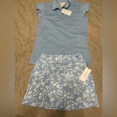 Nwt. Smoke Free Home. Both Pieces Have Upf 50 Uv Protection. Size Small Blue Polo With Zipper At Neckline And Dainty Flutter Sleeves. Size Xs Skort With A Wide Waistband, 2 Side Pockets And A Zippered Back Pocket. 14.25” Length Of Skirt. 3” Inseam Of Spandex Shorts. Polyester/Spandex Blend. Fitted Blue Shorts For Tennis, Fitted Golf Shorts For Spring, Blue Tennis Skort For Spring, Fitted Golf Skort For Summer, Casual Fitted Golf Shorts, Blue Casual Tennis Skort, Casual Blue Tennis Skort, Fitted Athleisure Skort For Golf, Athleisure Fitted Skort For Golf