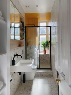 a bathroom with two sinks, a toilet and a walk in shower next to each other