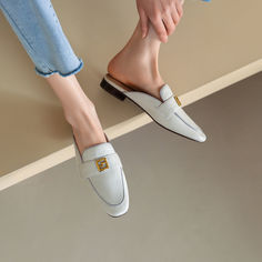 Handmade from premium leather. these loafer mules are really comfortable and breathable. Boasting metallic decoration. these flat beige mules help you show an easy chic look.These leather mules are also versatile enough for work or some other formal occassions. Upper: Genuine Leather Lining: Genuine Leather Outsole: Rubber Toe: Round Toe Closure: Slip on Color: Green. Beige is_handmade: Yes Spring Slip-on Flats With Metal Feet, Elegant Mules With Metal Feet And Round Toe, Spring Mules With Metal Feet, Summer Slip-on Office Loafers, Elegant Beige Flat Heel Slippers, Elegant Beige Flat Heel Mules, Elegant Flat Heel Mules For Office, Chic Round Toe Mules For Office, Trendy Closed Toe Office Mules