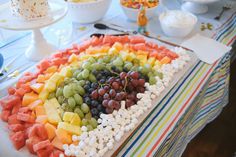 a platter filled with fruit and marshmallows on top of a table