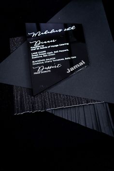 black business card with white writing on it