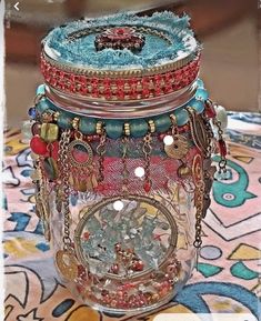 a glass jar filled with lots of jewelry