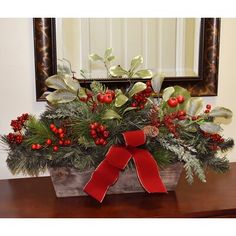 a wooden box filled with holly and red berries