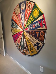 a colorful wheel hanging on the side of a wall