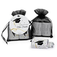 two graduation favors in black and white bags