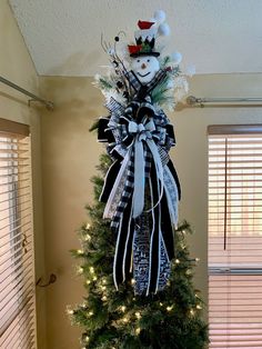 a decorated christmas tree in the corner of a room