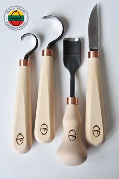 three wooden utensils with metal handles and spoons