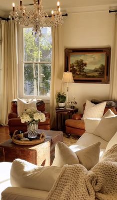 a living room filled with furniture and a chandelier