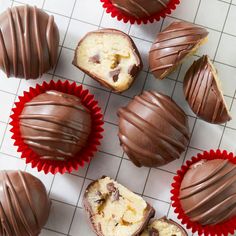 several chocolate covered desserts sitting on top of a white tile counter next to each other