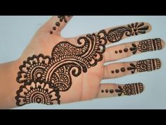 a hand with henna tattoos on it