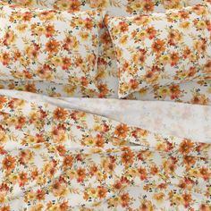 an image of a bed with floral sheets and pillowcases on top of it