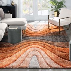 a modern living room with an orange and gray rug