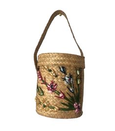 a woven basket with flowers and butterflies painted on the side, hanging from a rope