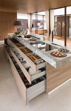 an open kitchen with lots of drawers in it