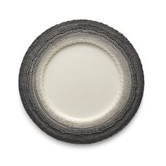 a white and black plate sitting on top of a table