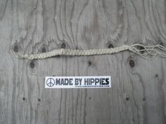 a sticker that says made by hippies on the side of a wooden wall