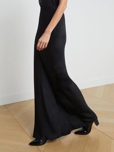 A stunning, understated maxi skirt in pure black. Bias-cut, silk-like fabric falls in a subtle, lustrous cling over the figure, enhancing and elongating the silhouette. Smooth elastic waist with no closures. | L'AGENCE Zeta Maxi Skirt In Black Sleek Black Satin Finish Maxi Dress, Full Length Satin Finish Maxi Dress, Sleek Full-length Bias-cut Maxi Dress, Silk Solid Color Flared Maxi Skirt, Evening Black Skirt With Side Slits, Elegant Maxi Skirt For Night Out, Black Evening Skirt With Side Slits, Elegant Black Bottoms With Satin Finish, Sleek Long Bias Cut Skirt